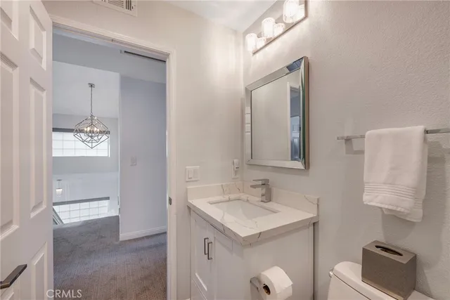 a view of a patio with table and chairs under an umbrella
