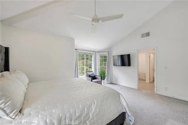 a view of a patio with a table and chairs under an umbrella