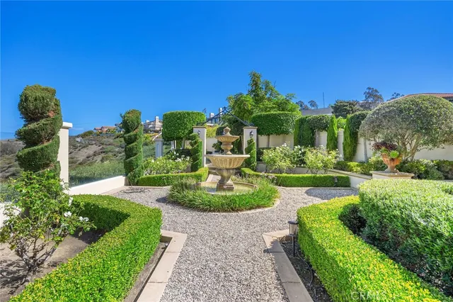 a view of a garden with a building in the background