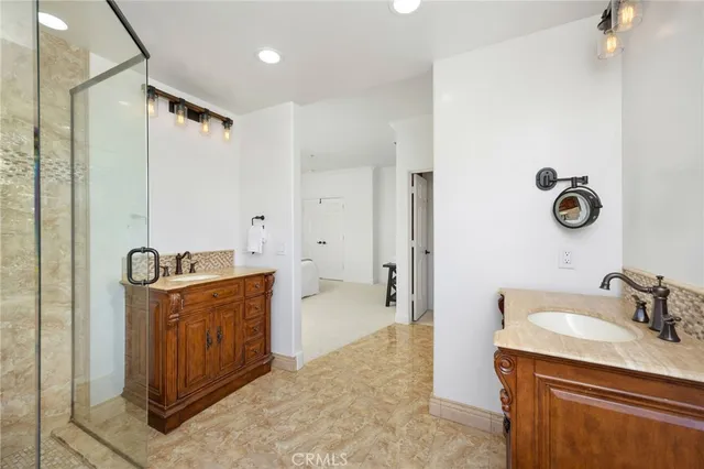 a bathroom with a sink a mirror and shower