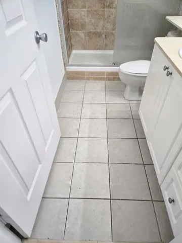 a bathroom with a toilet and a shower
