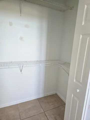 a kitchen with a refrigerator sink and cabinets