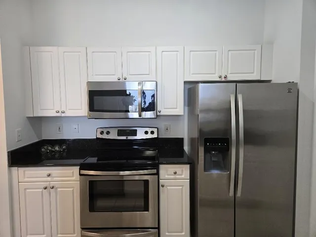 a bed sitting in a bedroom next to a wooden cabinet