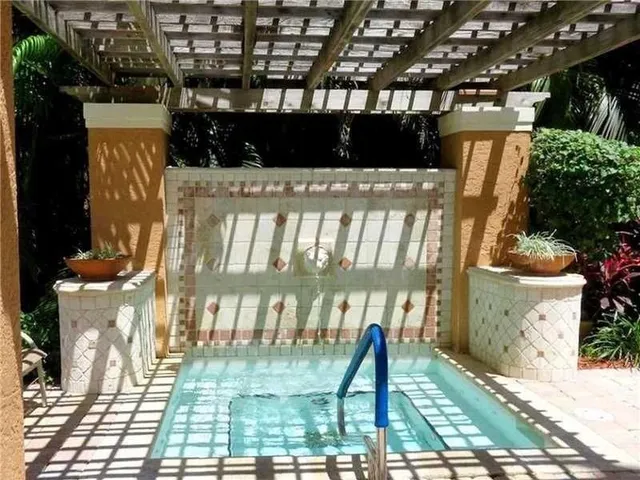 a view of a backyard with a garden and swimming pool