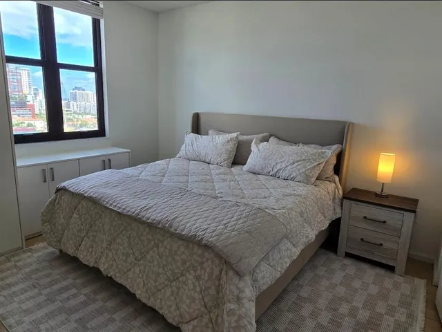 a bedroom with a bed and a window