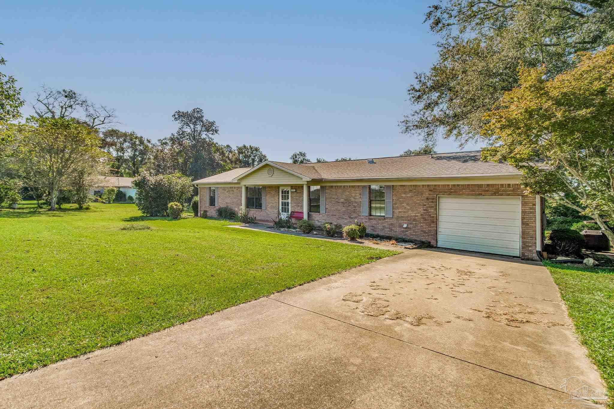6201 Meadows Road Walnut Hill, FL 32568 - Photo 4 of 50 a front view of house with yard and green space