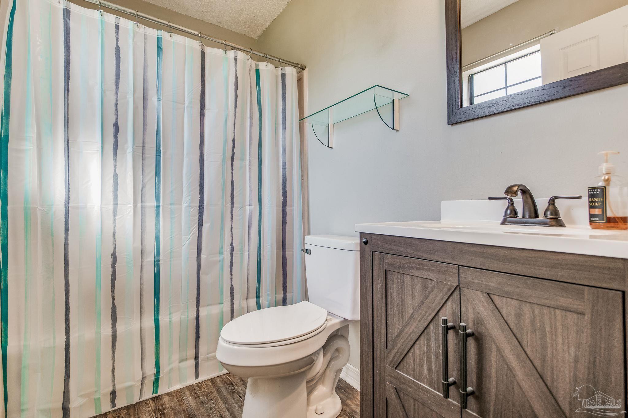 6201 Meadows Road Walnut Hill, FL 32568 - Photo 50 of 50 a bathroom with a sink a toilet and shower