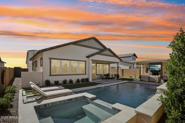 a view of house with swimming pool outdoor seating