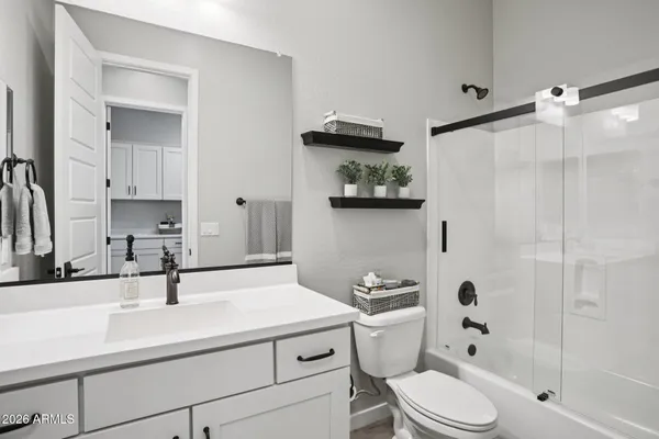 a bedroom with a bed and a ceiling fan