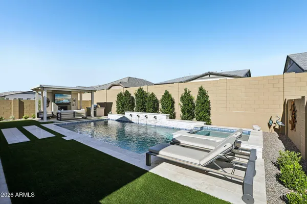 a view of a house with pool and chairs
