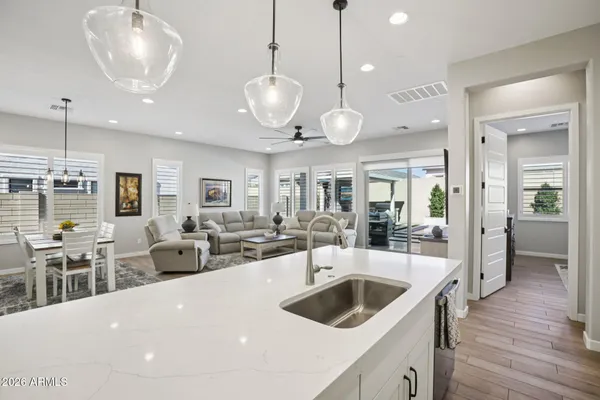 a kitchen with stainless steel appliances a stove and white cabinets