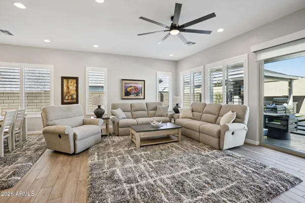 a living room with furniture wooden floor and a table
