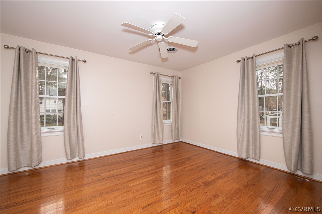 4010 Poplar Grove Road Midlothian, VA 23112 - Photo 27 of 49 a view of an empty room with wooden floor and a window