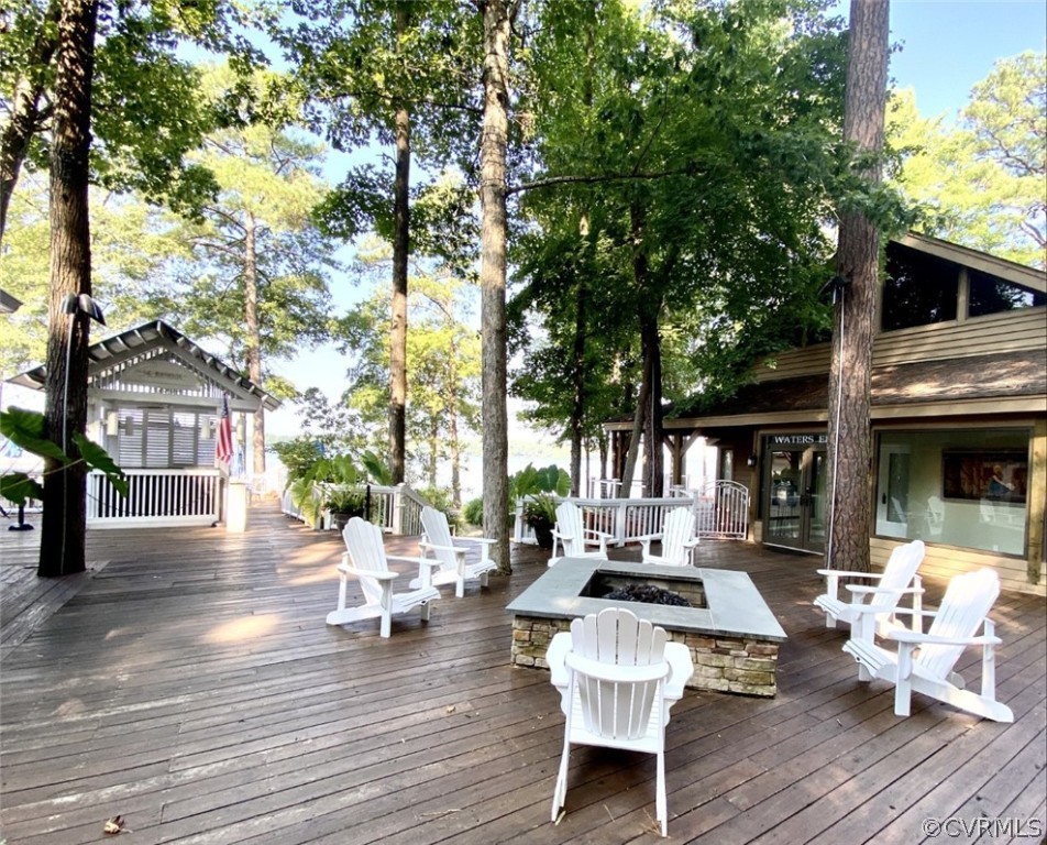 4010 Poplar Grove Road Midlothian, VA 23112 - Photo 41 of 49 a view of a patio with dining table and chairs with wooden floor and fence