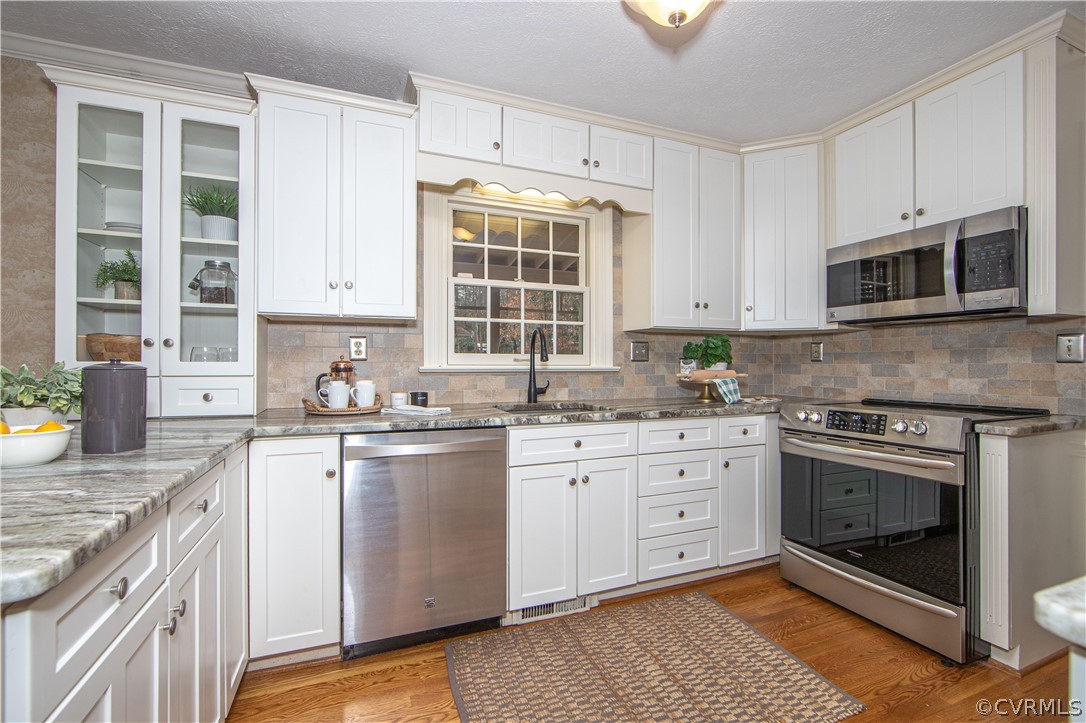 4010 Poplar Grove Road Midlothian, VA 23112 - Photo 9 of 49 a kitchen with stainless steel appliances granite countertop a stove sink and cabinets