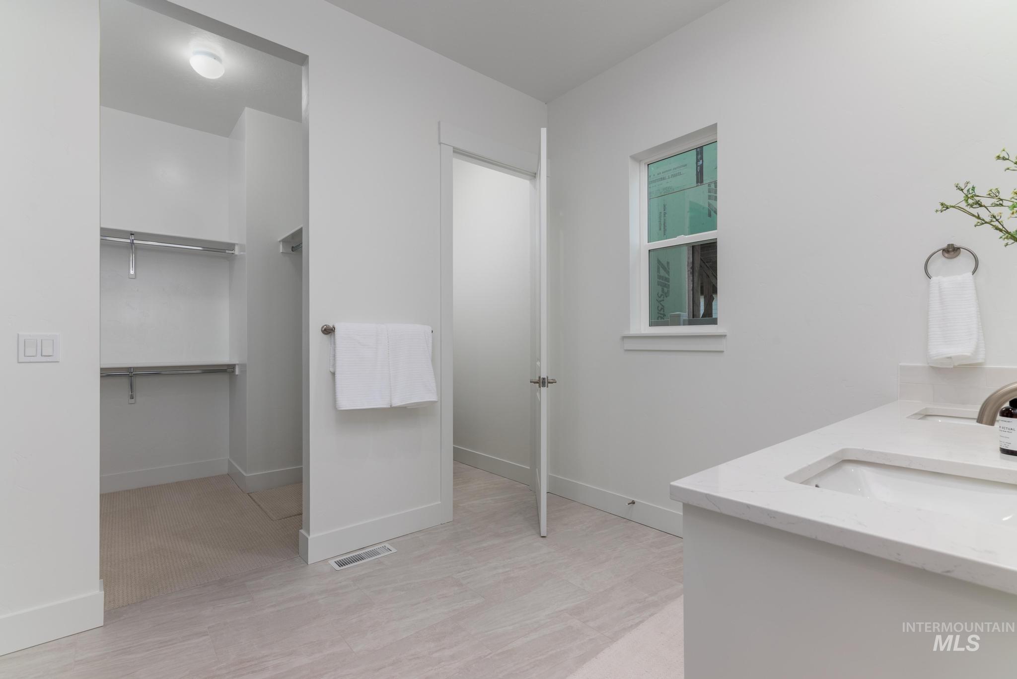 8520 West Fanning Street Star, ID 83669 - Photo 8 of 11 Bathroom with double vanity and a walk in closet