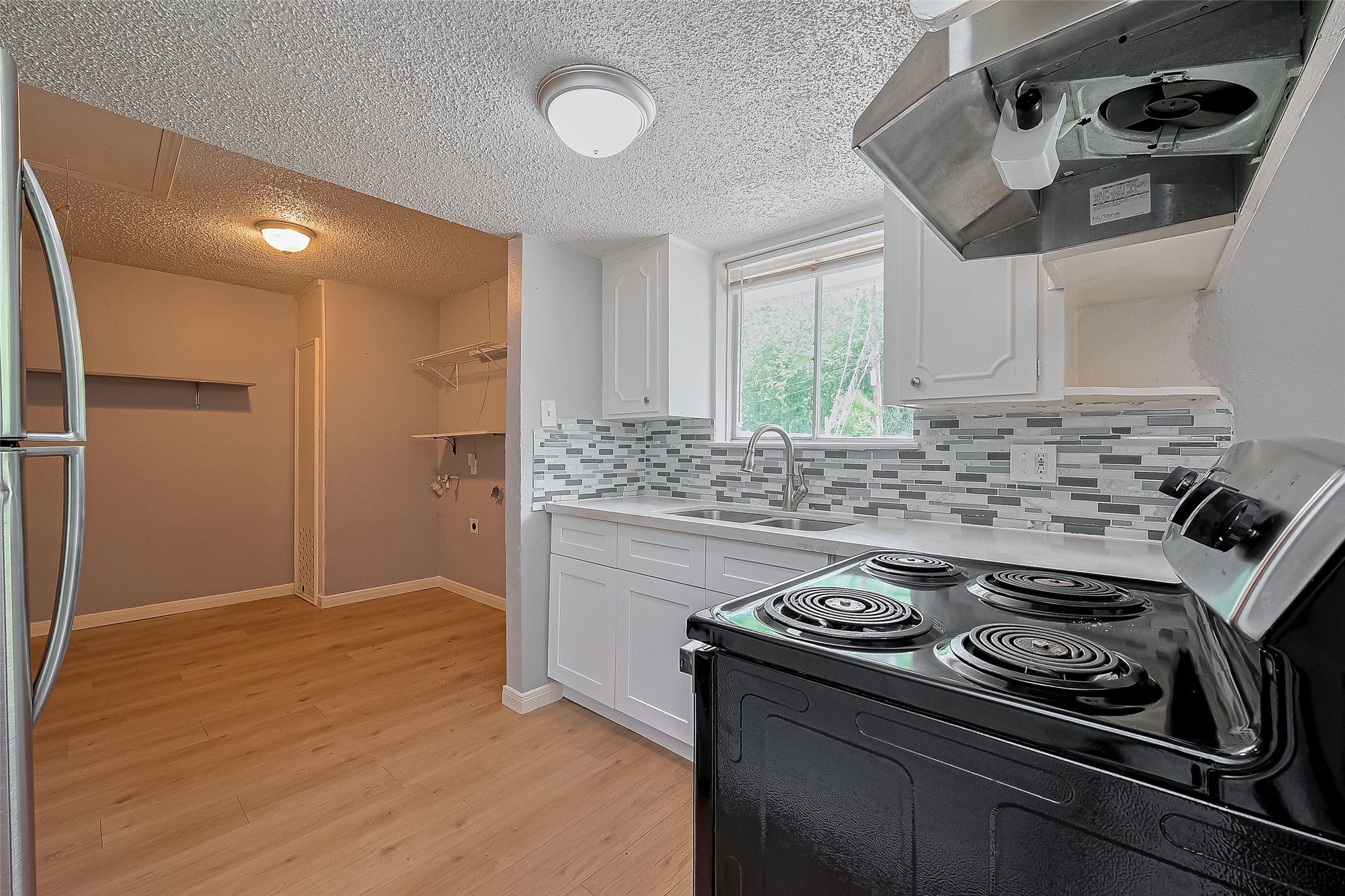 206 Beaver Bend Road Houston, TX 77037 - Photo 17 of 38 a kitchen with a stove and white cabinets