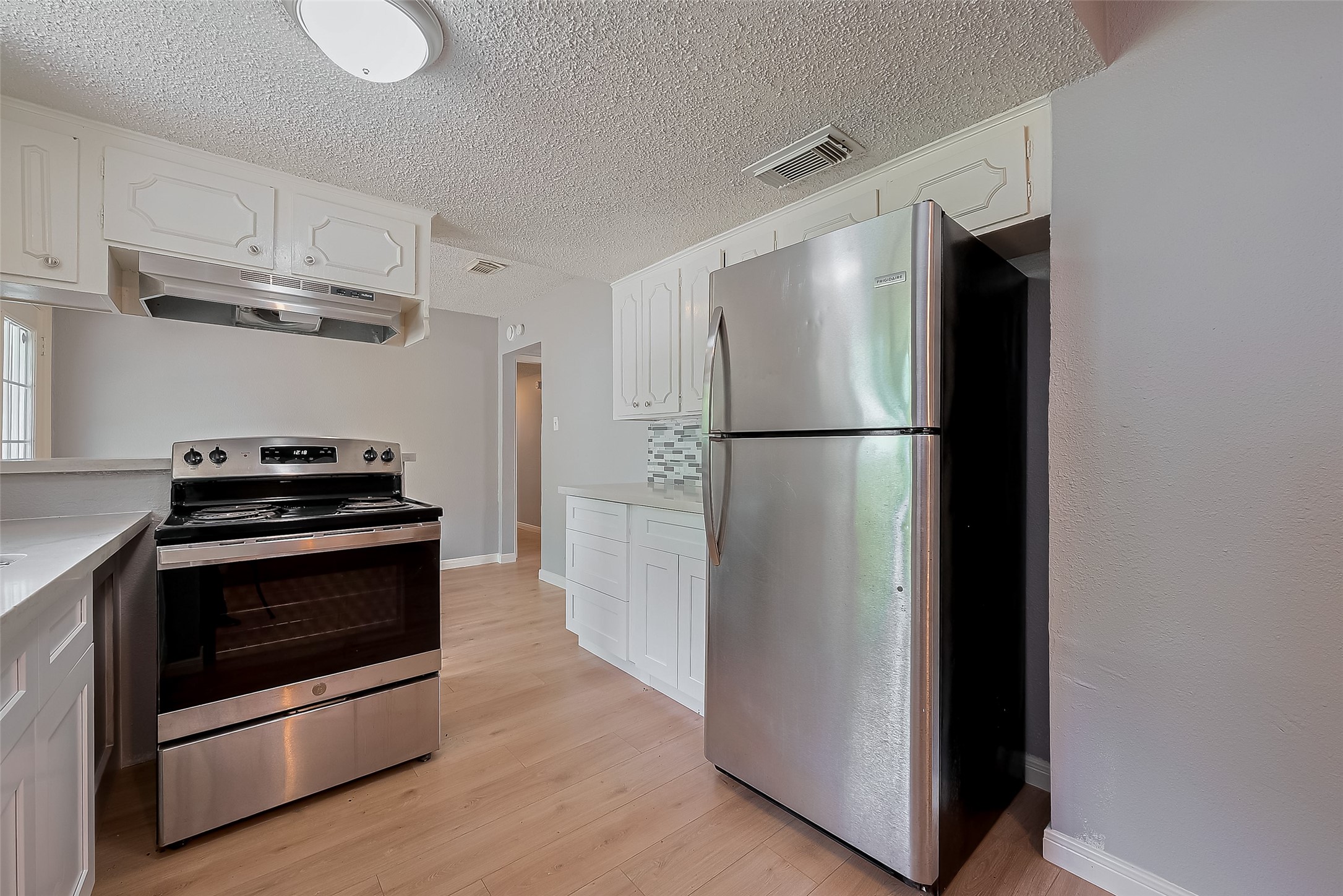 206 Beaver Bend Road Houston, TX 77037 - Photo 19 of 38 a kitchen with cabinets and stainless steel appliances