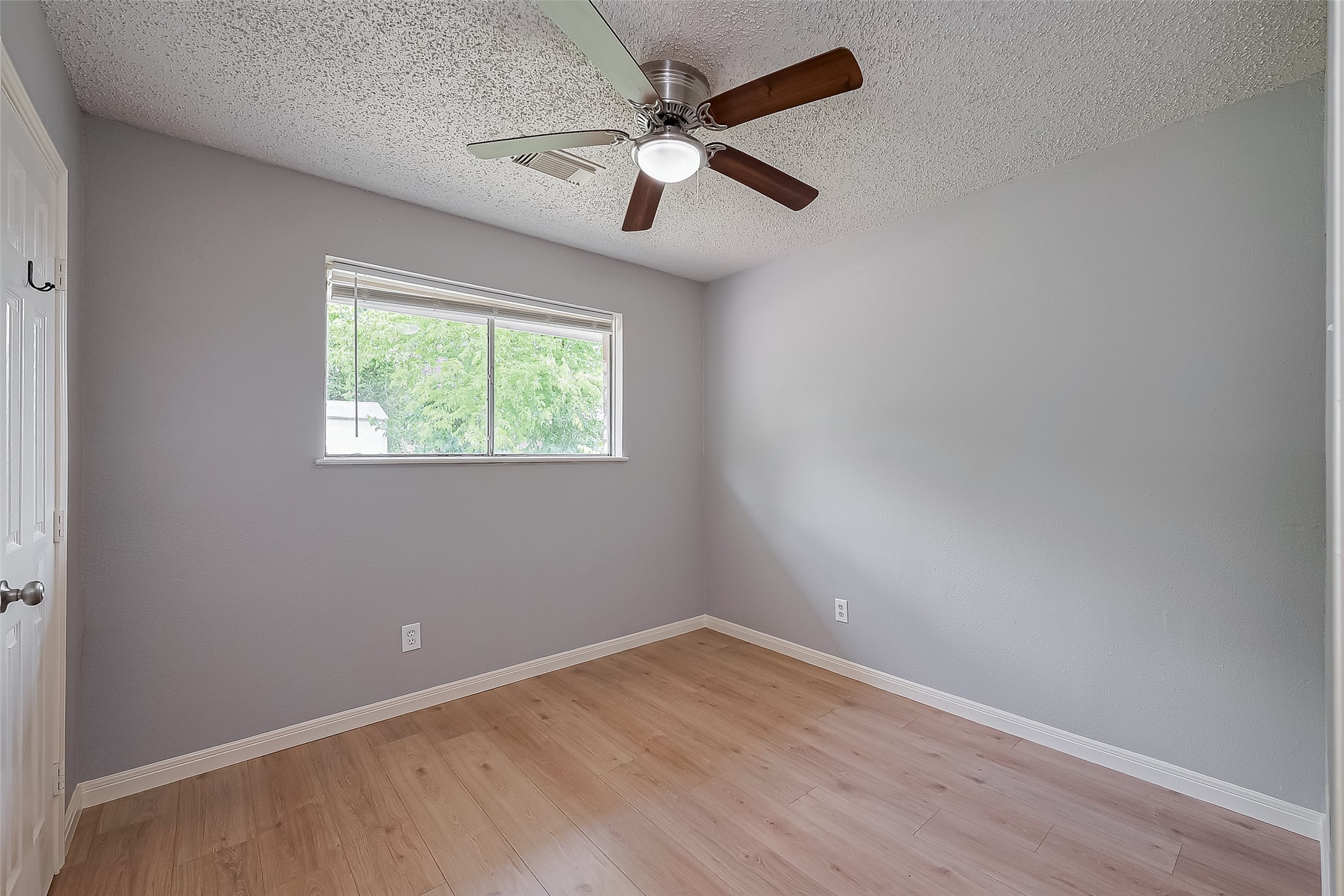 206 Beaver Bend Road Houston, TX 77037 - Photo 26 of 38 an empty room with a window and a fan
