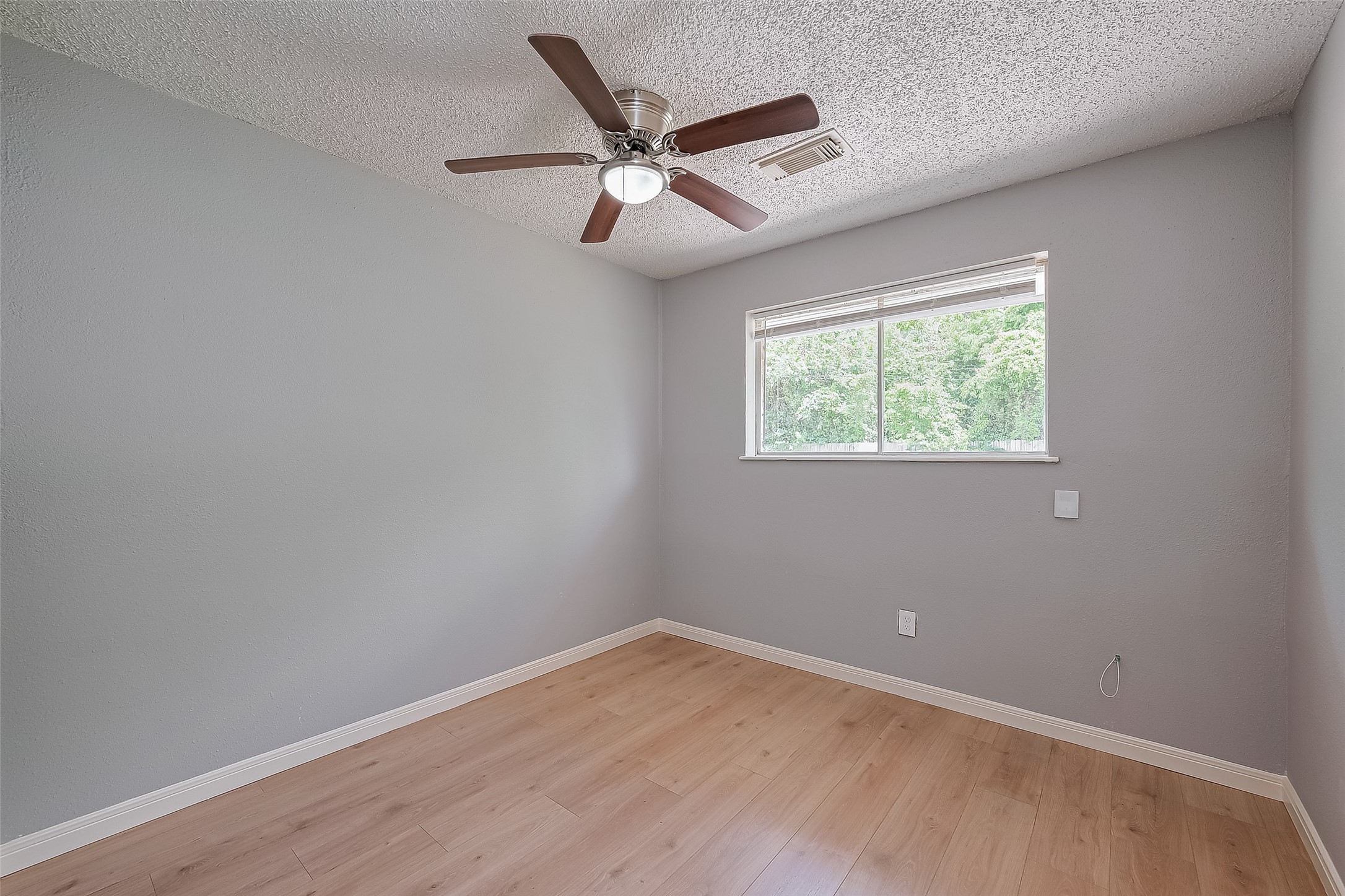 206 Beaver Bend Road Houston, TX 77037 - Photo 27 of 38 an empty room with wooden floor and windows