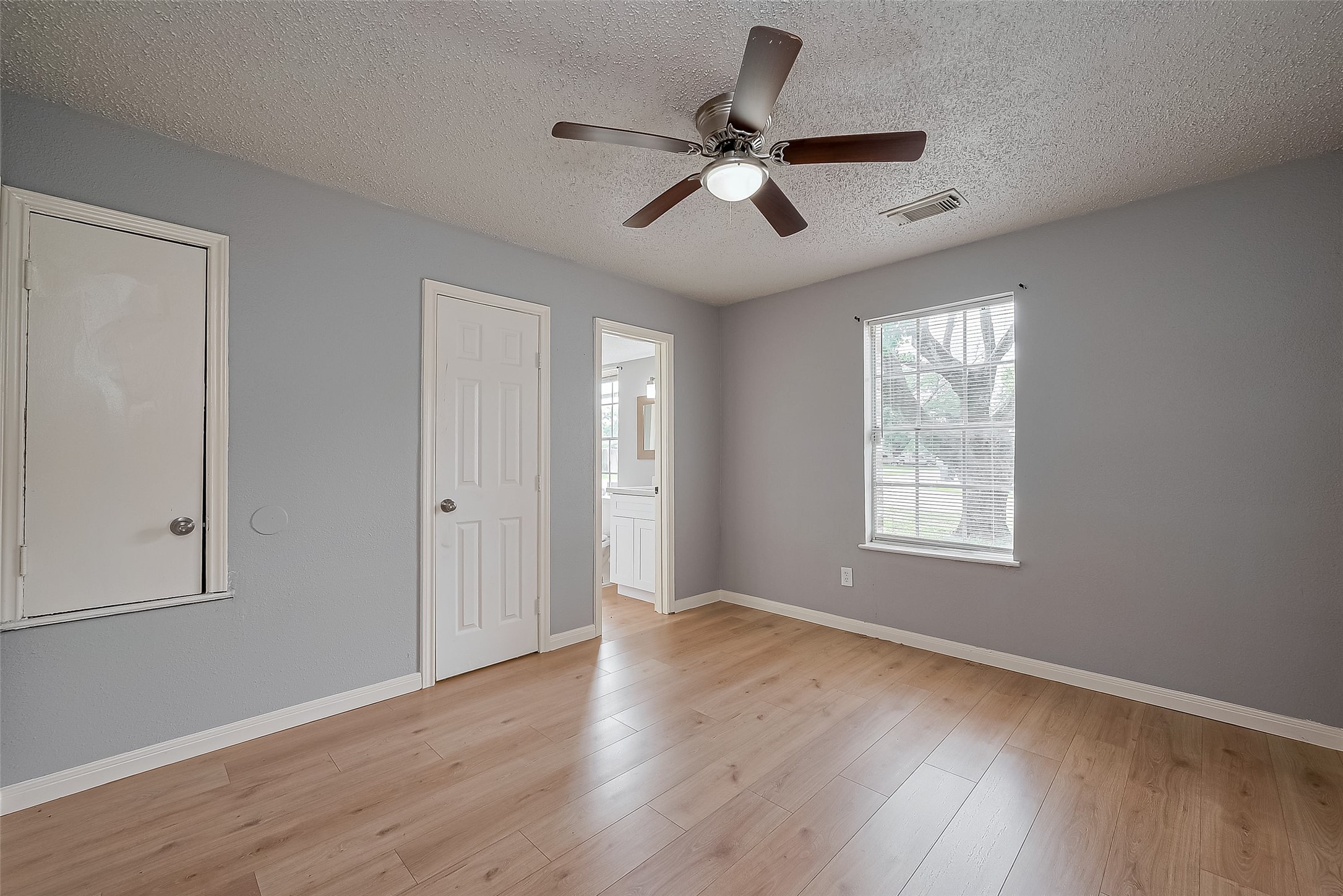 206 Beaver Bend Road Houston, TX 77037 - Photo 28 of 38 a view of an empty room with wooden floor and a window