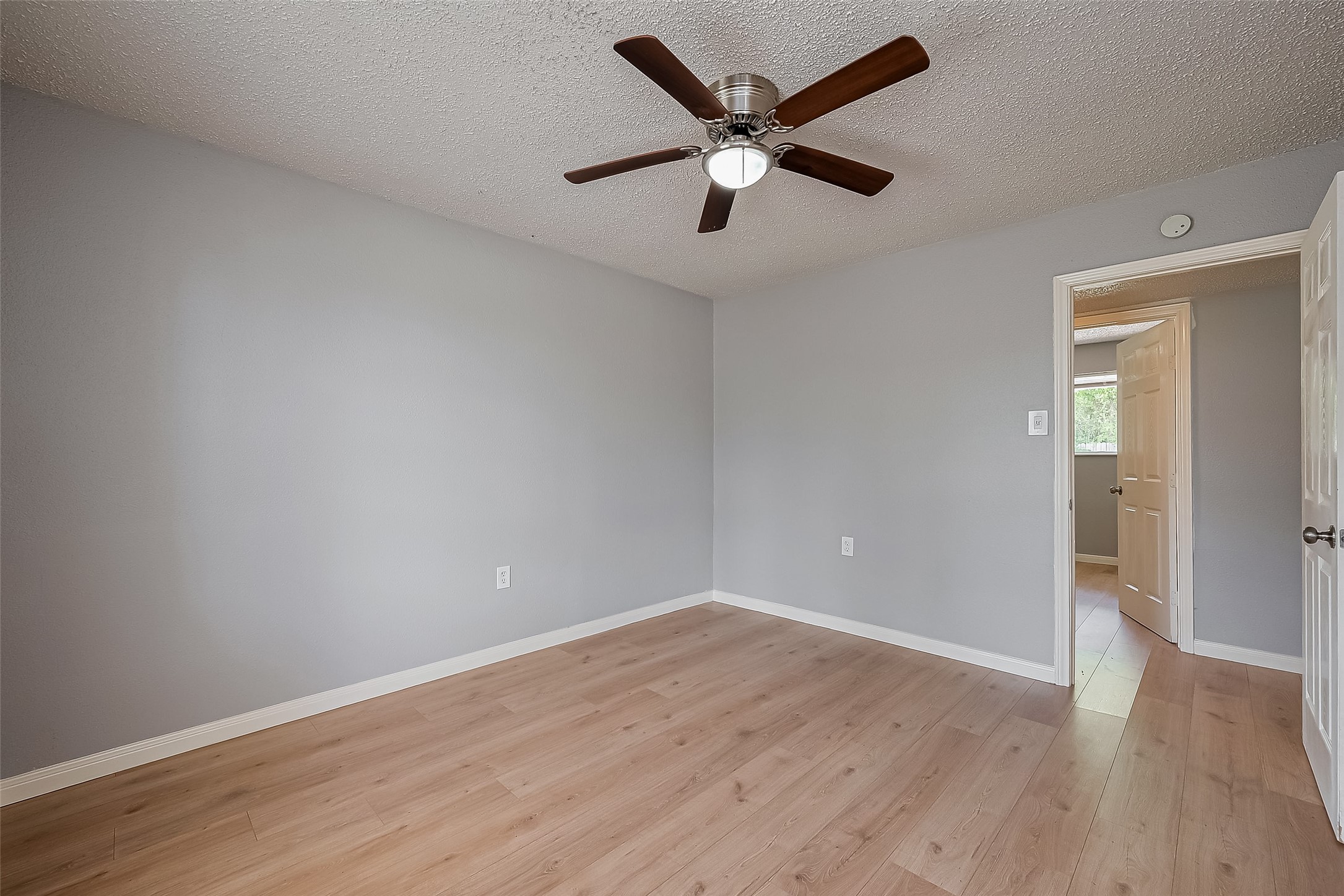 206 Beaver Bend Road Houston, TX 77037 - Photo 30 of 38 an empty room with wooden floor and windows