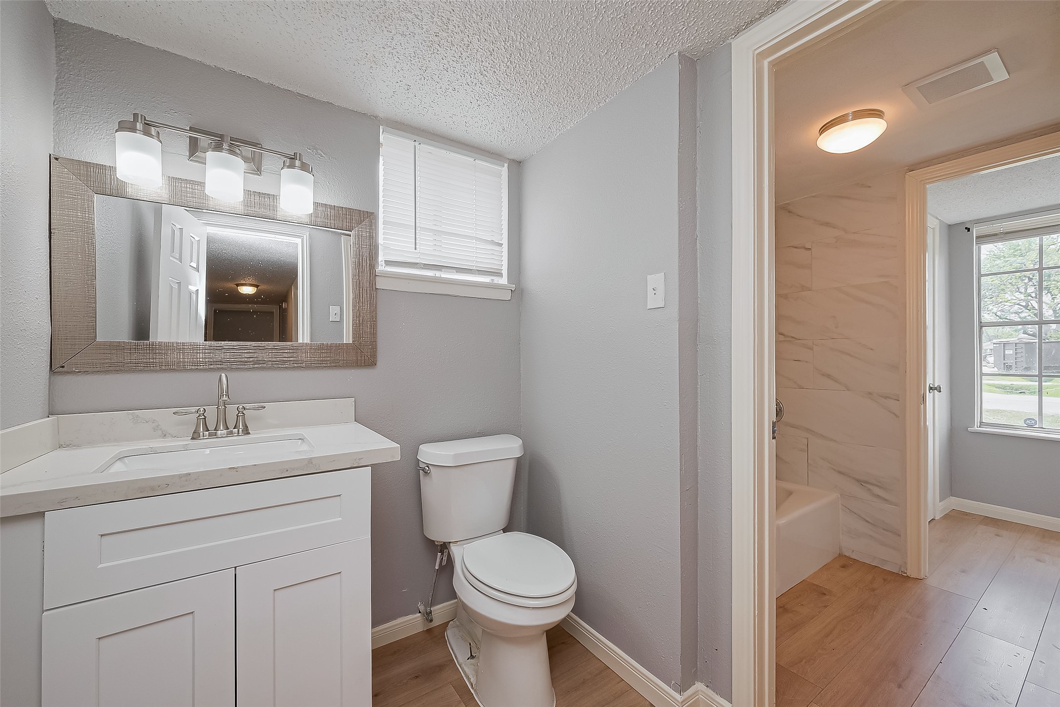 206 Beaver Bend Road Houston, TX 77037 - Photo 3 of 38 a bathroom with a toilet sink and mirror