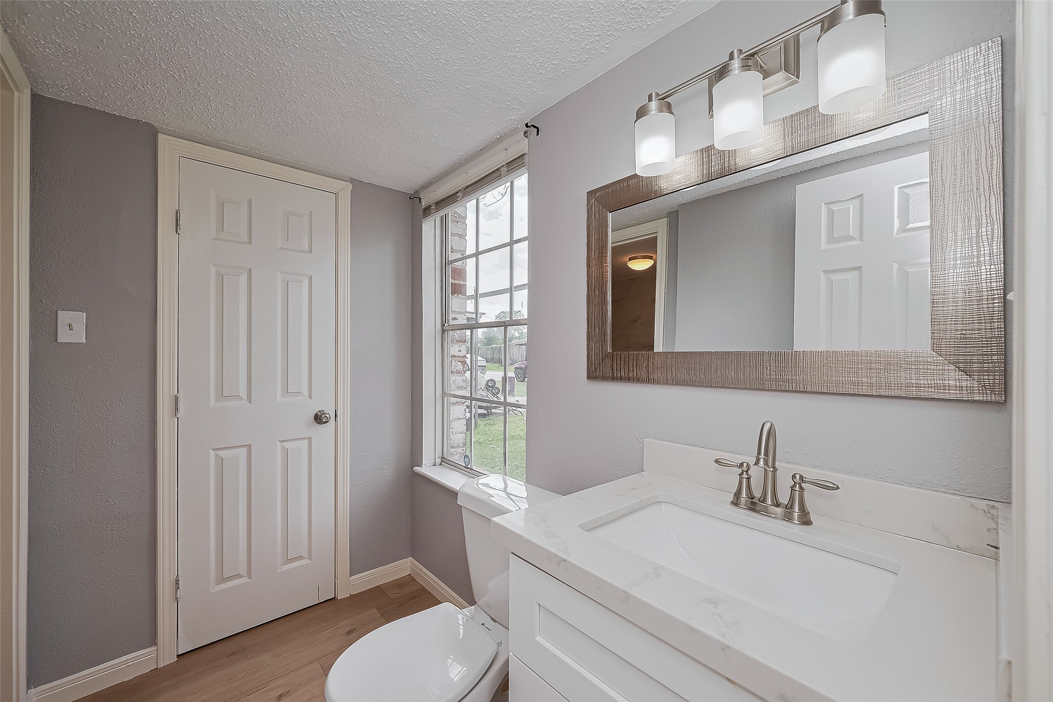 206 Beaver Bend Road Houston, TX 77037 - Photo 31 of 38 a bathroom with a sink vanity granite toilet and a mirror