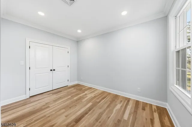 a view of room with window and hardwood floor
