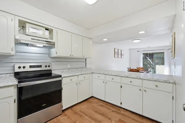 a kitchen with granite countertop cabinets stainless steel appliances and sink