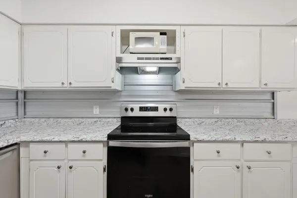 a stove top oven sitting inside of a kitchen
