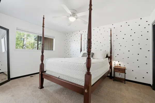 a bed room with a bed and a window