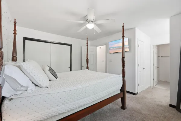 a bedroom with a bed and a mirror