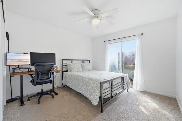 a bedroom with a bed and a desk