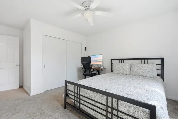 a bedroom with a bed and a chandelier