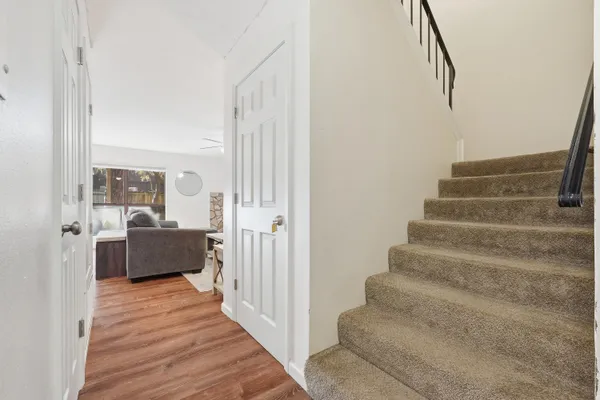 a view of entryway and hall with wooden floor