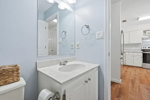 a bathroom with a sink a toilet and a mirror