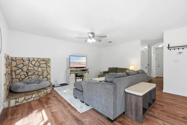 a living room with furniture and a wooden floor