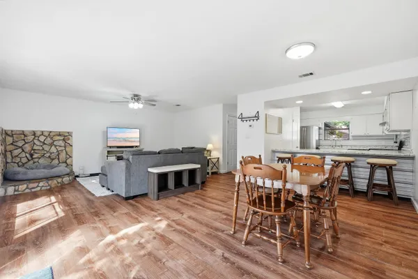 a view of a dining room with furniture and wooden floor