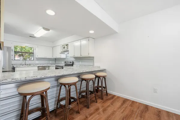 a kitchen with a table and chairs in it