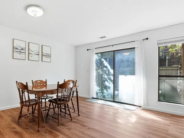 a view of a dining room with furniture and windows