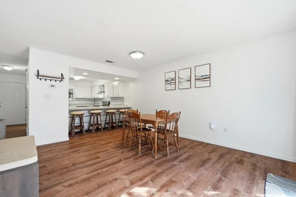a view of a dining room with furniture and wooden floor