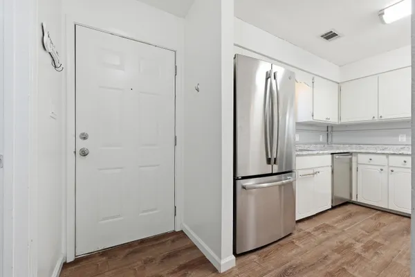 a kitchen with white cabinets and white stainless steel appliances
