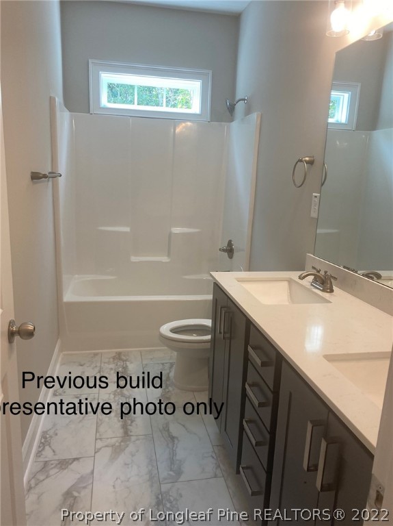 760 Daphne Lane Vass, NC 28394 - Photo 13 of 15 a bathroom with a sink a toilet a mirror and shower