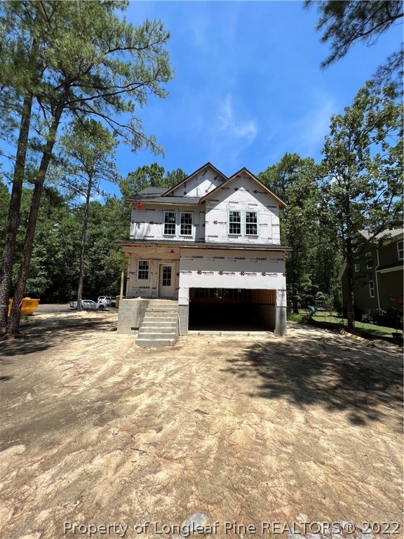 760 Daphne Lane Vass, NC 28394 - Photo 3 of 15 a front view of a house with a yard and garage