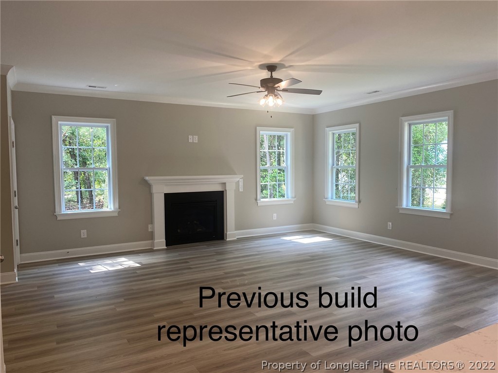 760 Daphne Lane Vass, NC 28394 - Photo 10 of 15 a view of an empty room with wooden floor and a window