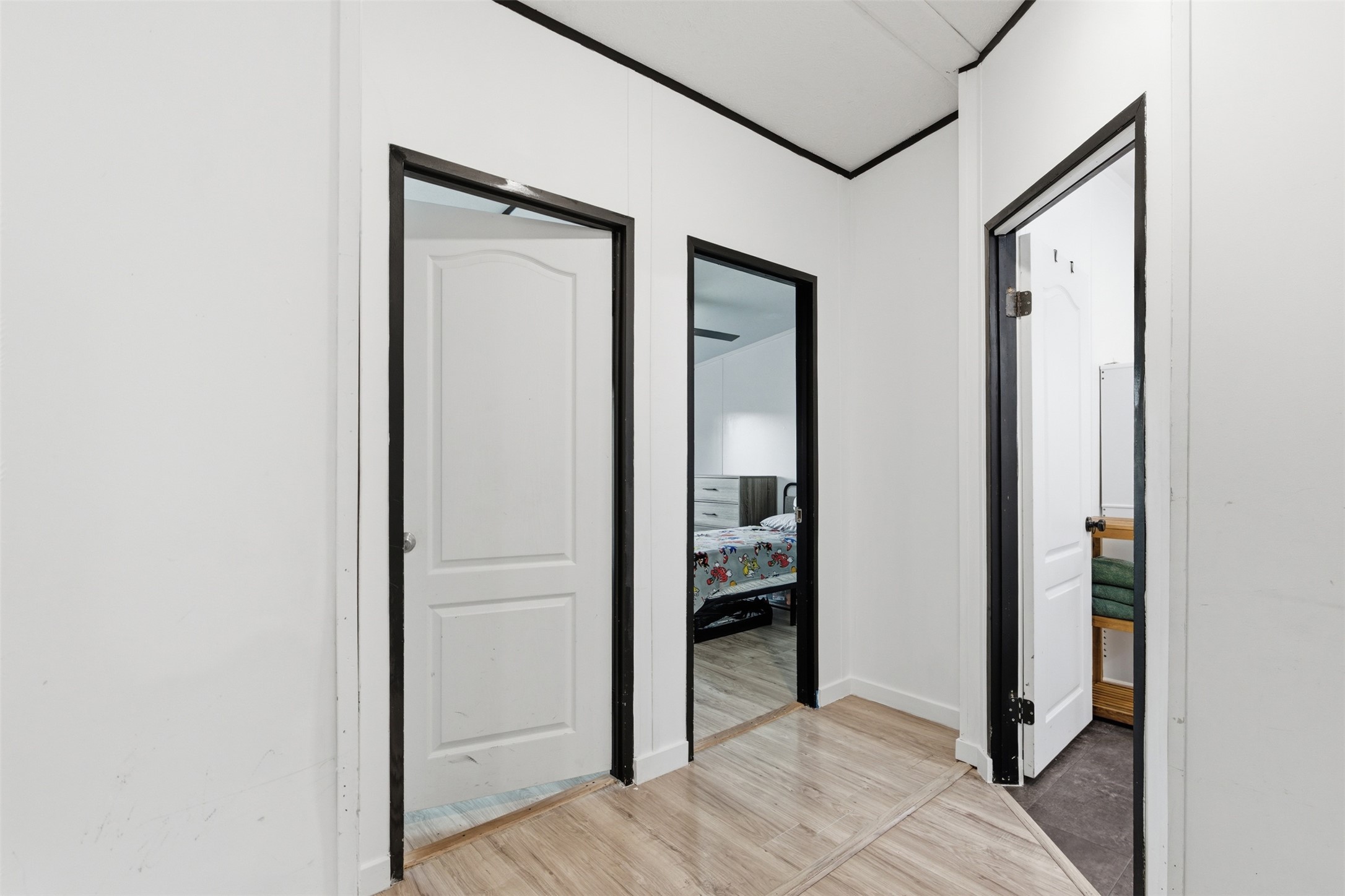 580 Railyard Drive Kyle, TX 78640 - Photo 15 of 20 The property features a hallway with light-toned flooring, white walls, and dark trim around door frames