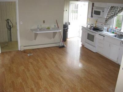 31 Old Stage Road Centerville, MA 02632 - Photo 3 of 4 a view of a kitchen with a sink wooden floor and a window