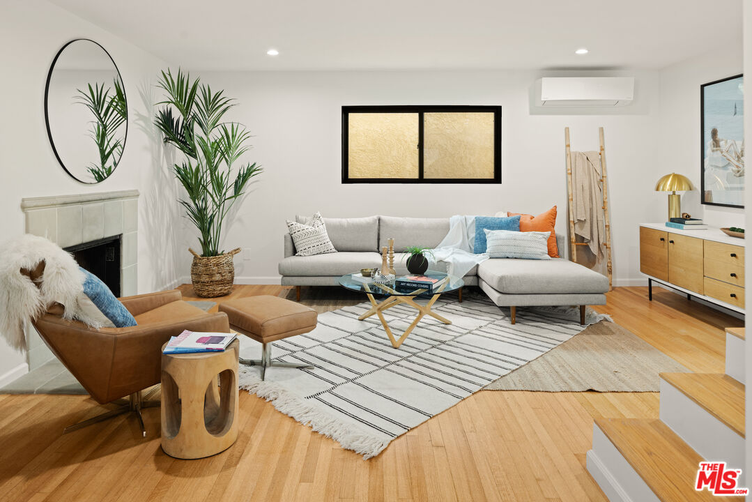 2613 5th Street Santa Monica, CA 90405 - Photo 11 of 30 a living room with furniture a fireplace and a potted plant