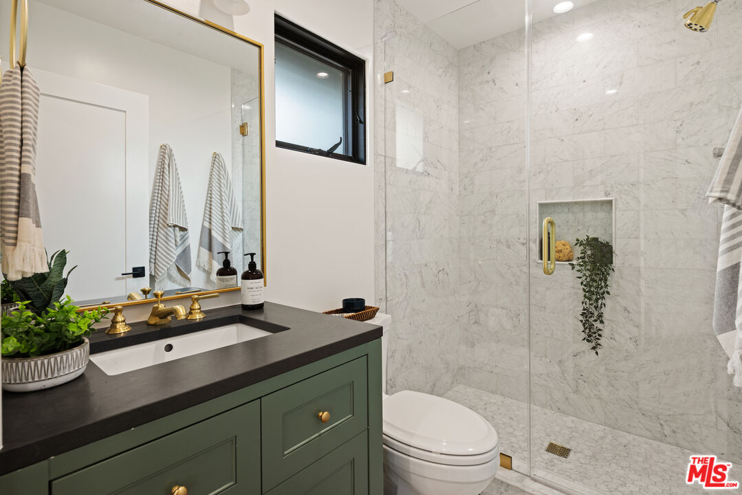 2613 5th Street Santa Monica, CA 90405 - Photo 19 of 30 a bathroom with a sink a toilet and shower